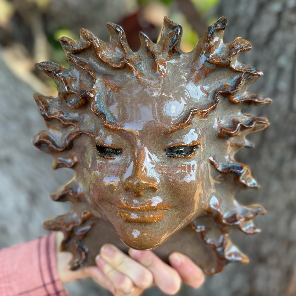 Vtg.Signed Celestial pottery wall hanging mask in brown glaze.